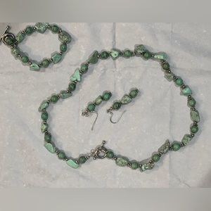 Handcrafted green and silver colored beads and stones on filament chain
